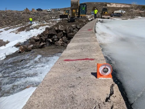 Stabilizing damaged portions of Panguitch Lake Dam with riprap