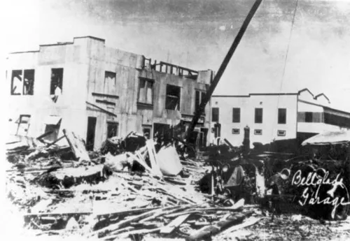 An automotive garage in Belle Glade, demolished by the 1928 hurricane, and surrounding debris. Wind and deep, fast-moving lake water destroyed homes, businesses, vehicles, utilities, and agricultural infrastructure. 
